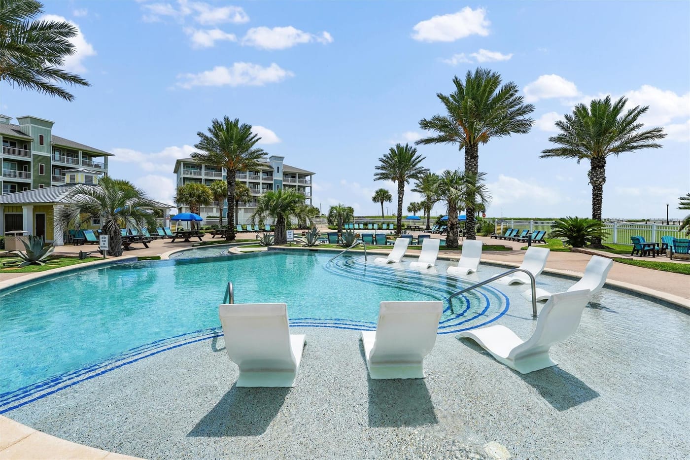 The family-friendly Pointe West resort pool framed by palm trees