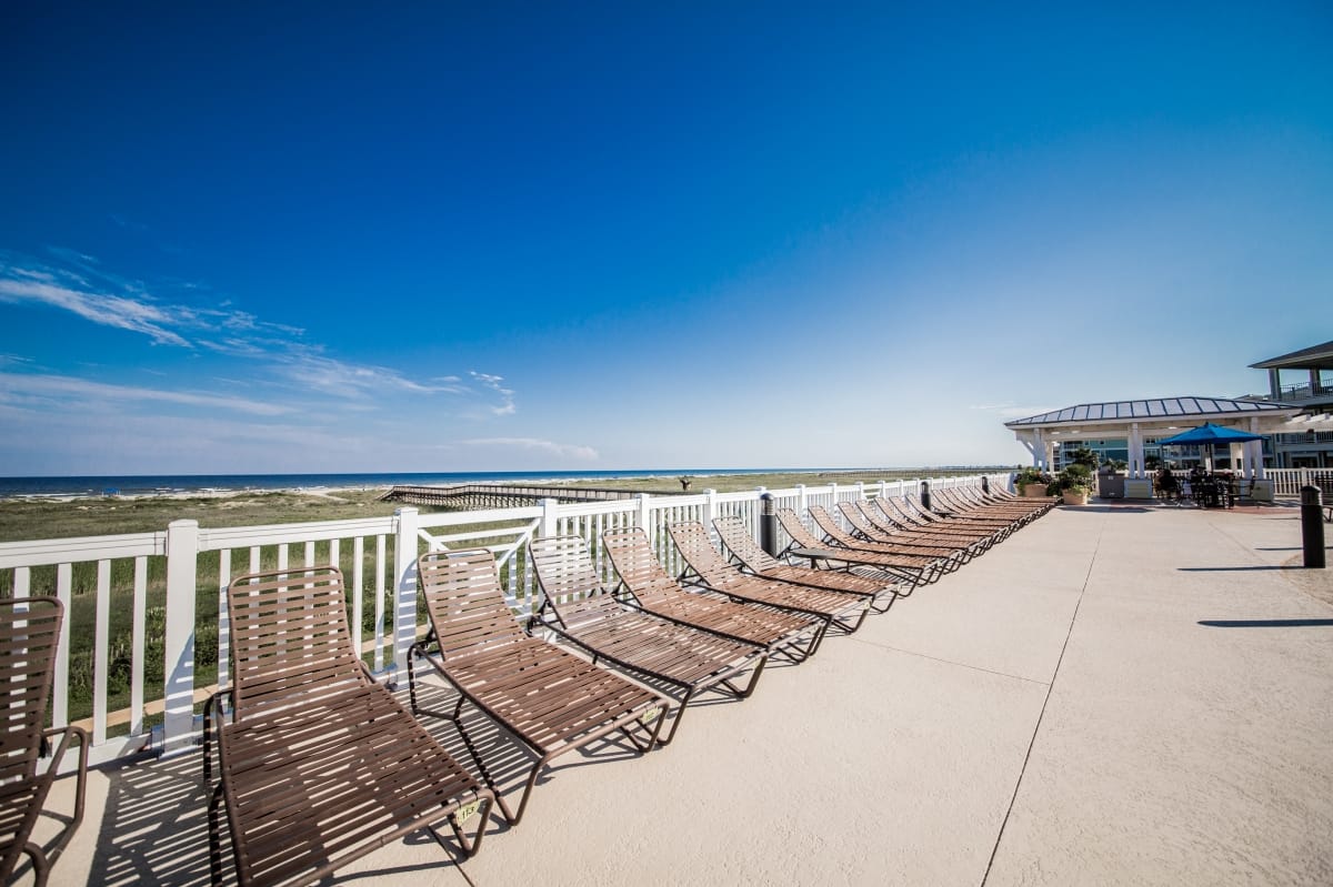 Pool deck loungers with beach views