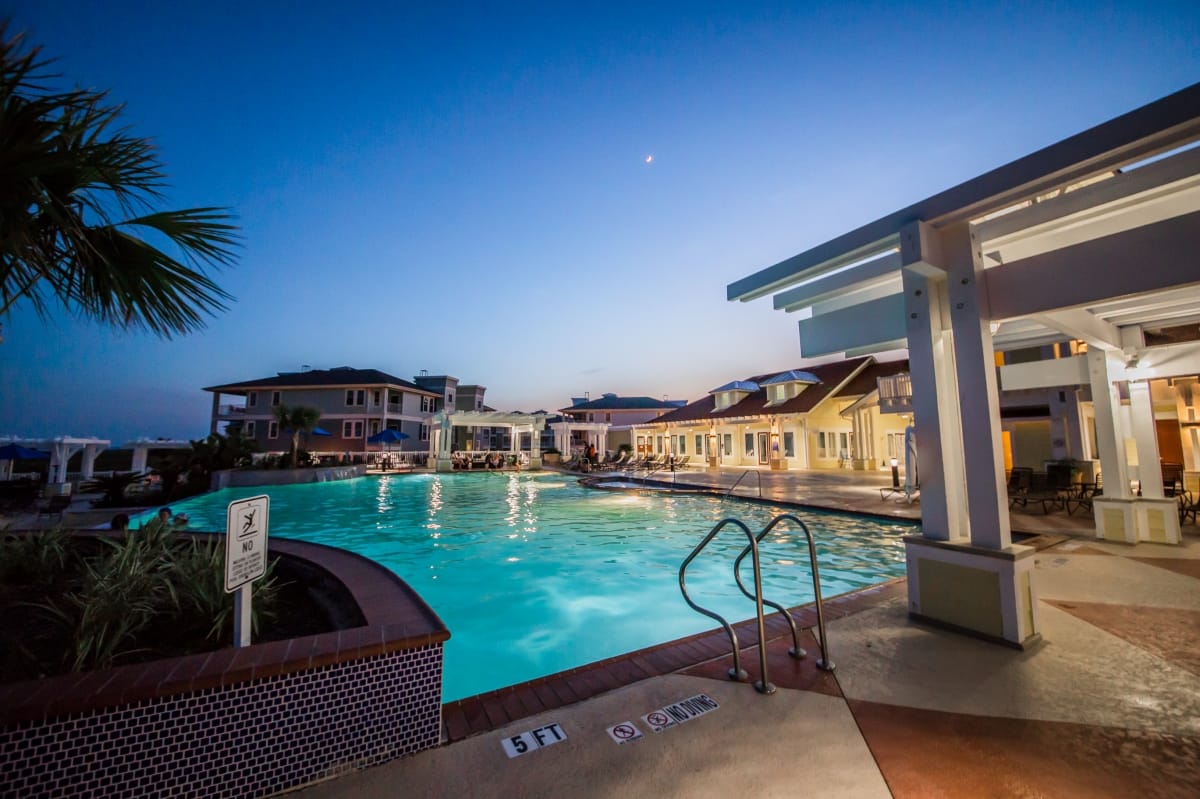 Pool and clubhouse at dusk